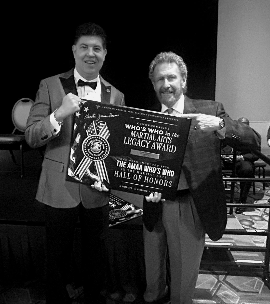 Mike Barefoot holding his AMAA Who's Who in the Martial Arts Legacy Award