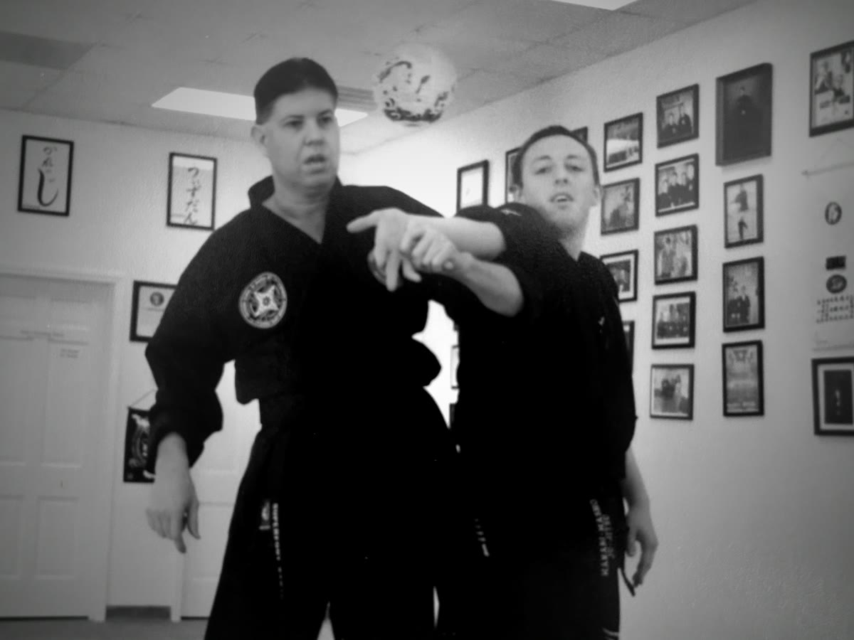 Mike Barefoot demonstrating a Ju-Jitsu wrist technique with a student in the dojo
